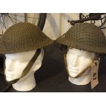 Two tin helmets one dated 1941