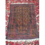 An Afghan red ground rug, 52" x 32"