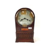 A dome topped Oak striking mantel clock