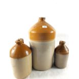 Three stoneware flasks, two titled "The