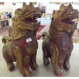 A pair of wooden temple dogs with red ground and gilding, height 21 1/2"