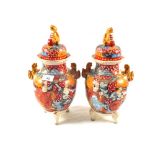 A pair of Satsuma lidded jars, figure painted with animal handles and finials, height 14"