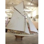 A model sailing boat on a stand, length 35"