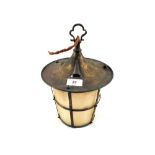 Arts and Crafts circular Brass lantern, the overhanging hood above tapering plaque glass shade,