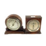 An Oak day dial calendar clock and a Mahogany aneroid barometer (glass cracked)