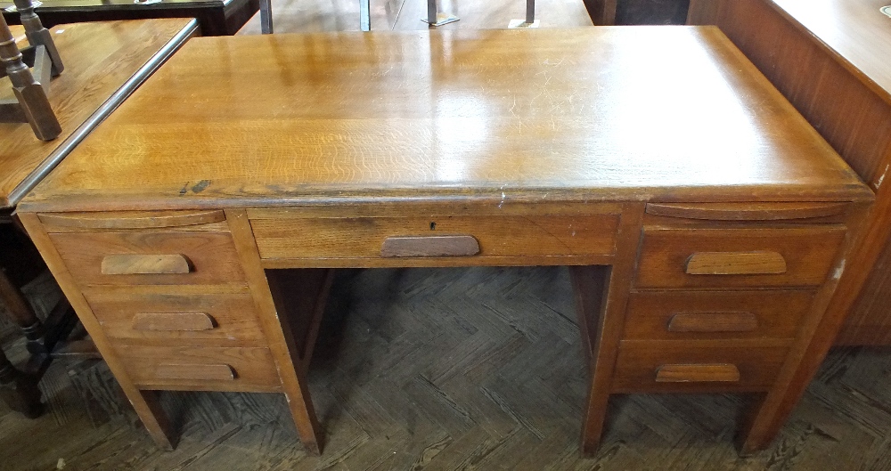 An Oak seven drawer pedestal desk