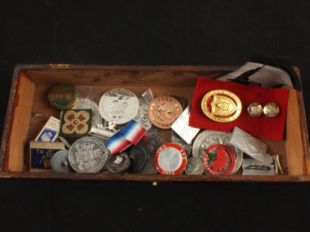 Small box containing various badges and medals
