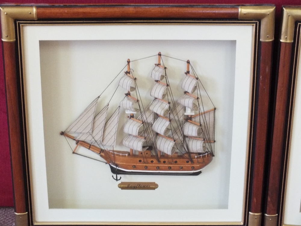 Two framed half hulls of sailboats "Cutty Sark" and "Mayflower"