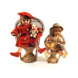 A pair of dolls on wicker chairs,