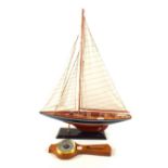 A wooden model yacht and a barometer