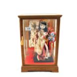 A Japanese pressed doll in glazed case