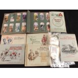 Various cigarette cards in albums and a bag of cigarette card silks