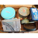 A suitcase containing an unopened Jacobs Cream Crackers export tin and other items