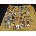 A collection of enamel bowls badges