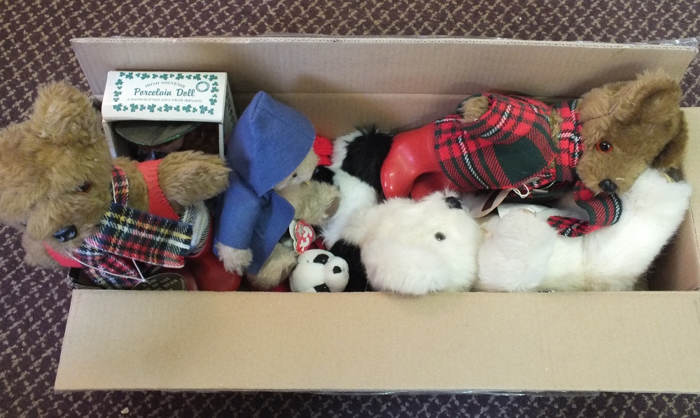 A doll and various soft toys