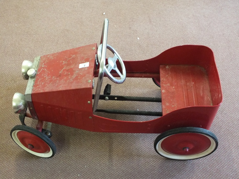 A tin plate pedal car