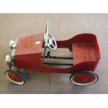 A tin plate pedal car