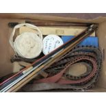 A collection of gun cleaning equipment including rods, brushes,