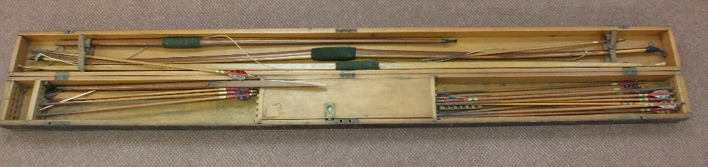 A cased set of three competition long bows and arrows and accessories by Aldred of London,