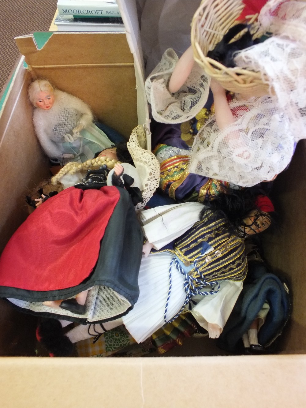 A box of various costume dolls