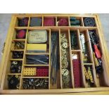 A wooden box containing various Meccano