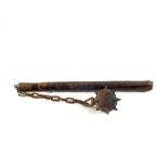 An Edwardian example of a flail with Iron spiked ball suspended on a chain from a wooden handle