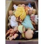 A box of various dolls