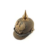 A WWI Pickelhaube felt example with Brass eagle plate, chin strap and cockades intact.