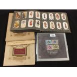 Various cigarette cards in albums and a pack of Silver Jubilee stamps