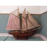 A wooden model of a two masted fishing boat,