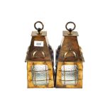 A pair of Arts and Crafts Brass and glass hanging lanterns with hooded tops