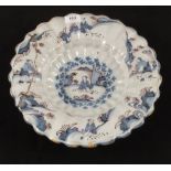 A 17th Century Delft shaped edge shallow bowl with blue and manganese Chinoiserie decoration,