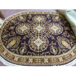 An oval mauve ground floral Axminster carpet,