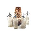 Four various soda siphons and a West German brown mottled pottery vase