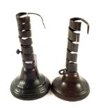 Two 18th Century iron spiral ejector candlesticks each on domed turned wood base,