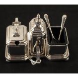 A Silver three piece cruet on stand with two spoons