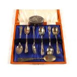 A cased set of six Silver coffee spoons, one Chinese spoon and a pill box,