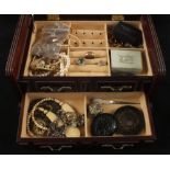 A jewellery box containing Amber earrings and other costume jewellery