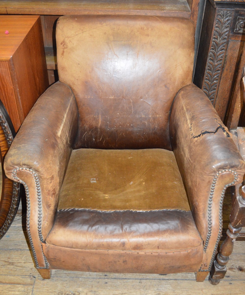 A leather armchair and a pair of Oak armchairs