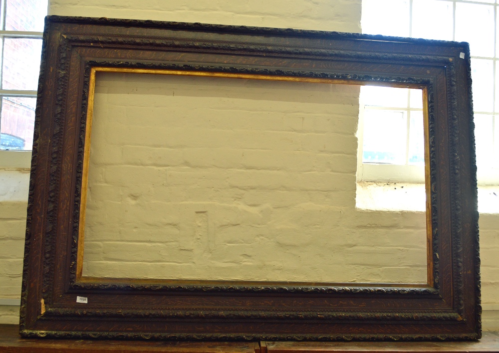 A large faux Oak picture frame