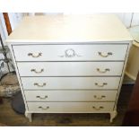 A white bedroom suite consisting of chest of five drawers, mirrored dressing table,