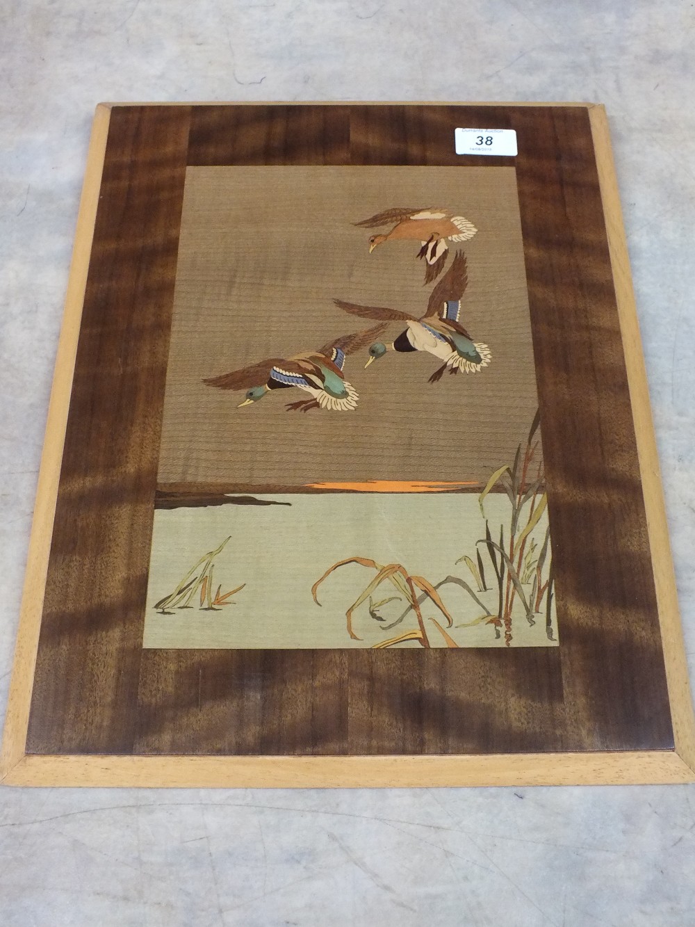 An inlaid wooden panel of flying ducks after a design by Peter Scott,