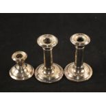 A pair of Silver candlesticks, Birmingham 1908 and one smaller,