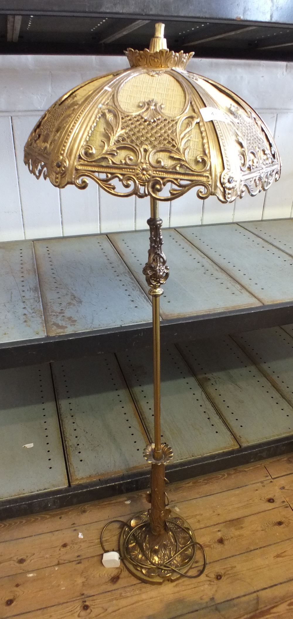 A gilt metal leaf form standard lamp and ornate shade