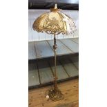 A gilt metal leaf form standard lamp and ornate shade