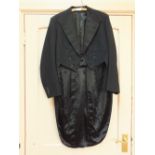 A frock coat, fur trimmed jacket,