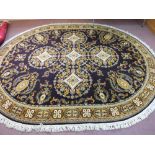 An oval mauve ground floral Axminster carpet,