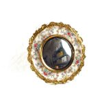 A Chintz pottery circular mirror with gilt metal leaf surround