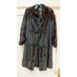 A lady's brown fur coat