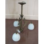 A Brass and floral three branch light fitting with milk glass shades
